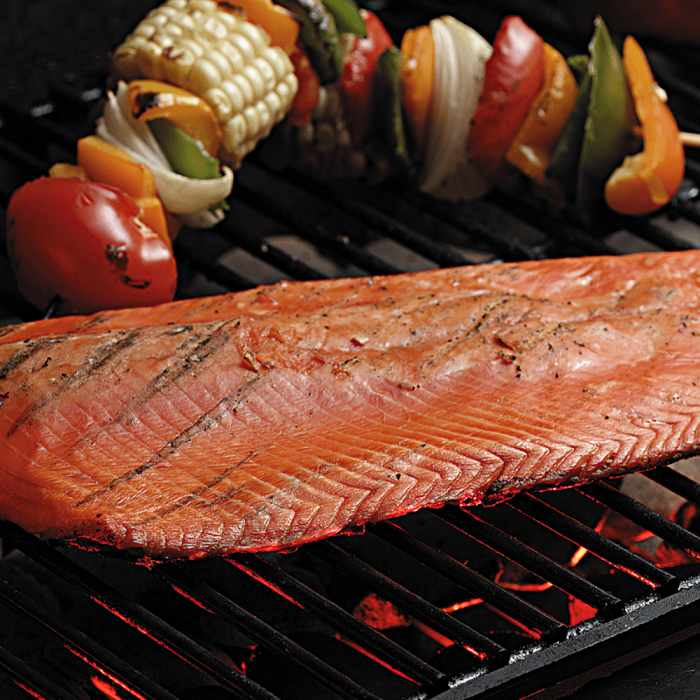 Whole sides of smoked salmon displayed on a simple background.